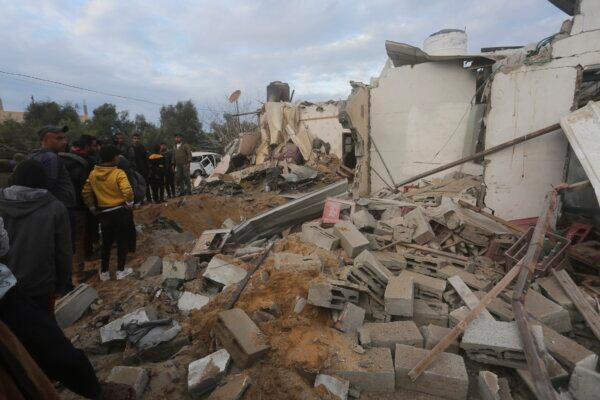 Palestinians look at a residential house destroyed in an Israeli strike in Rafah, Gaza Strip, on Feb. 5, 2024. (Hatem Ali/AP Photo)