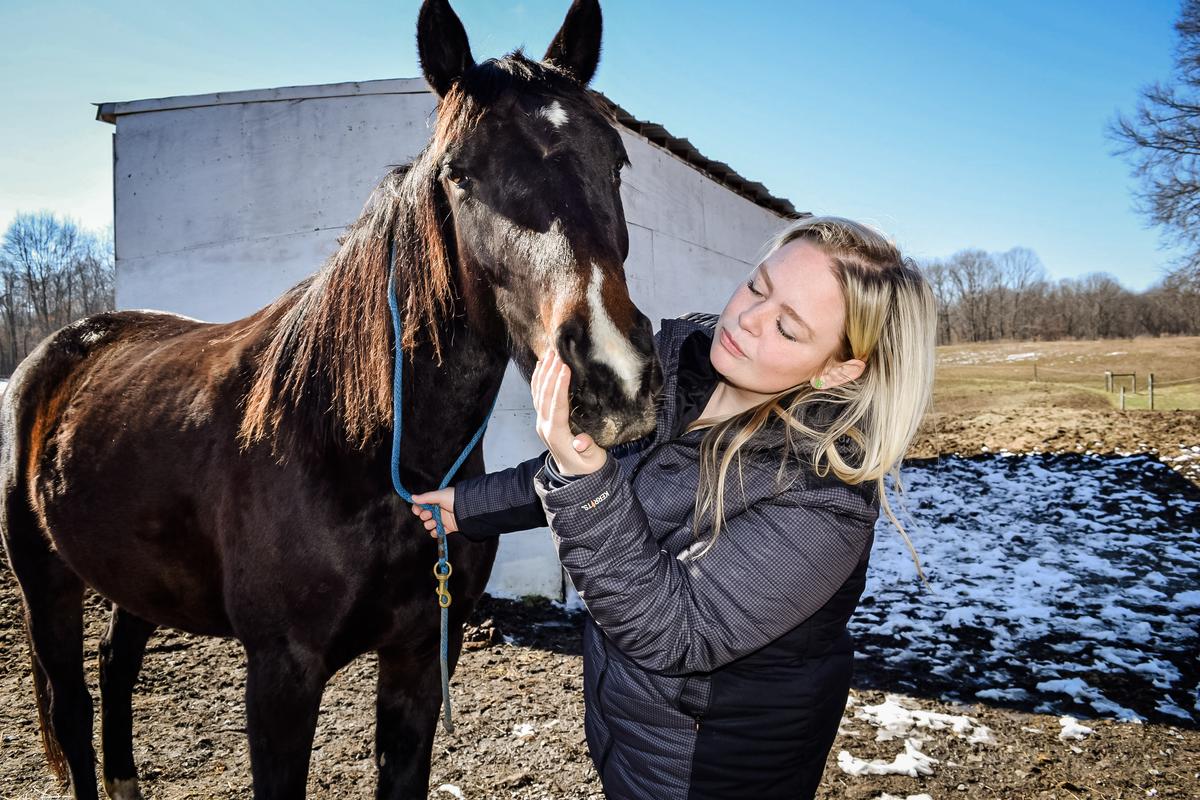 Julie Kent with her horse Haley, at her farm, located about a mile from the February 2023 Norfolk Southern train derailment and chemical spill site, in Darlington, Pa., on Feb. 20, 2024. (Beth Brelje/The Epoch Times)