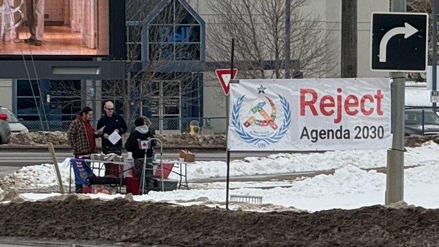 Edmonton rally-goers set up an information table and a Reject Agenda 2030 banner on March 9, 2024. (Courtesy Emmott Kelsey)