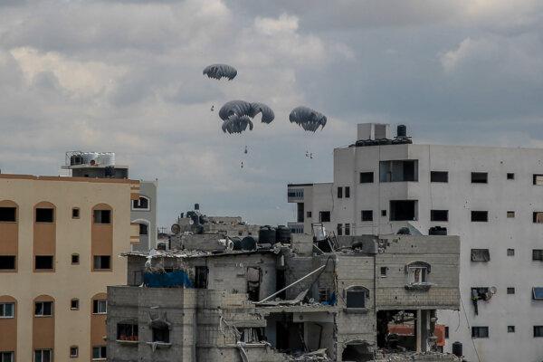 Humanitarian aid parcels attached to parachutes are airdropped from a military aircraft over the Gaza Strip, on March 25, 2024. (-/AFP via Getty Images)