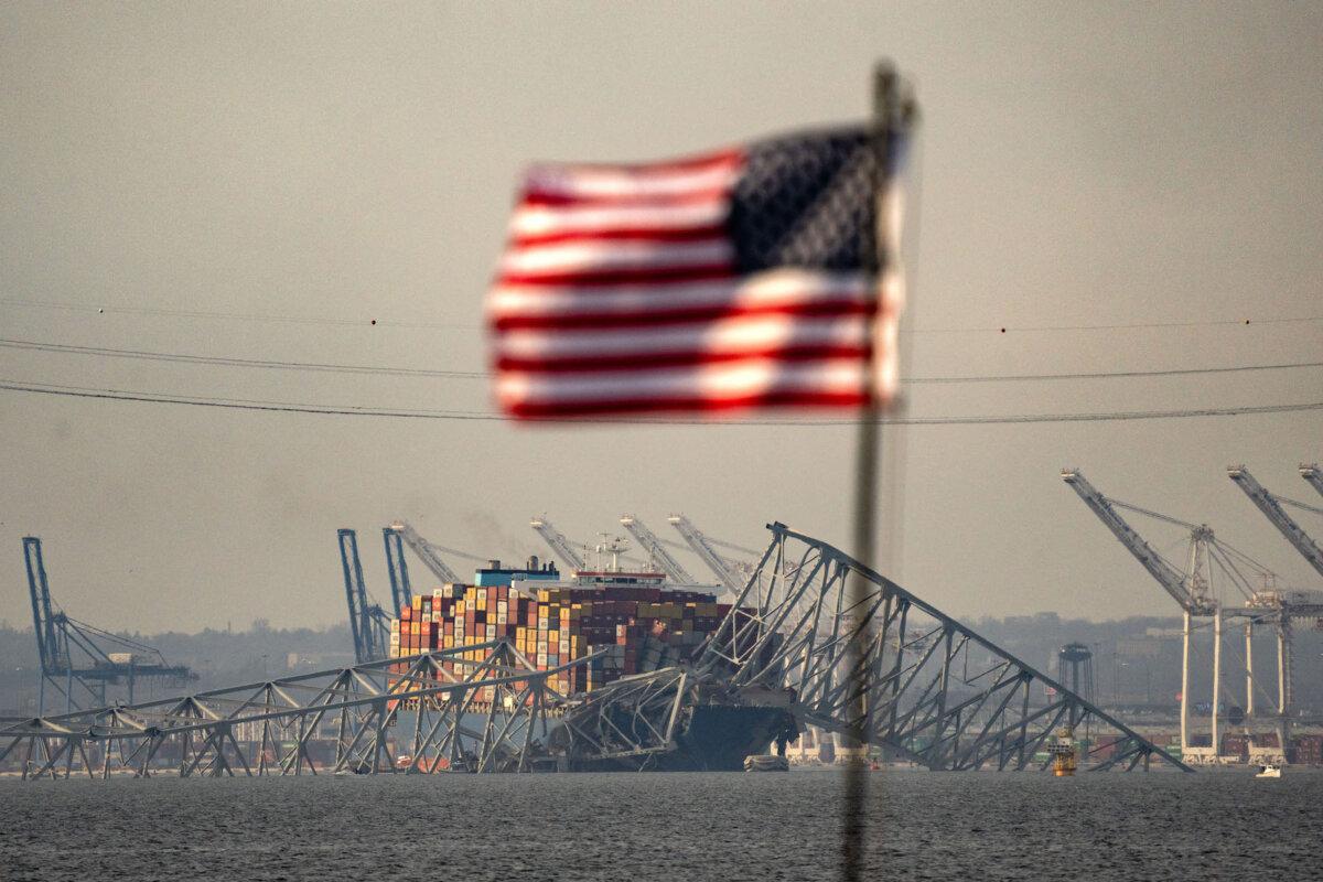 Part of the steel frame of the Francis Scott Key Bridge sits on top of the container ship Dali after the bridge collapsed in Baltimore, Md., on March 26, 2024. (Kent Nishimura/AFP via Getty Images)