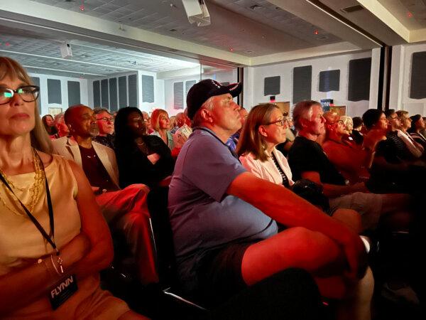 Audience members watch the premiere of the documentary "Flynn—Deliver the Truth. Whatever the Cost," in Venice, Fla. on April 5, 2024. (Patricia Tolson/The Epoch Times)
