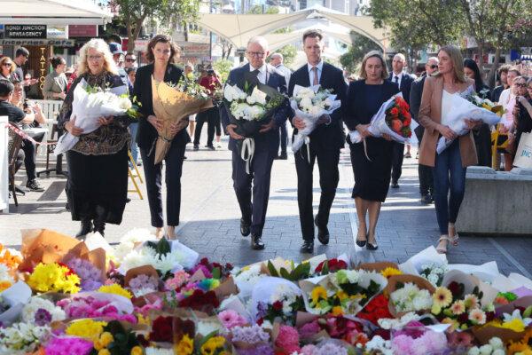 Prime Minister Anthony Albanese, NSW Premier Chris Minns (C) and Allegra Spender (L) lay floral tributes at Oxford Street Mall at Westfield Bondi Junction in Bondi Junction, Australia, on April 14, 2024. (Lisa Maree Williams/Getty Images)