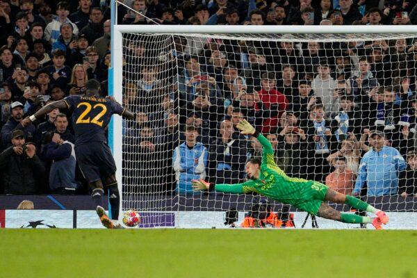 Manchester City's goalkeeper Ederson (R) fails to save the shot as Real Madrid's Antonio Rudiger scores the winning penalty during a shootout during the Champions League quarterfinal second leg soccer match between Manchester City and Real Madrid in Manchester, England, on April 17, 2024. (Dave Shopland/AP Photo)
