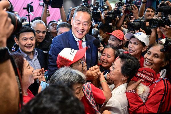 Pheu Thai Party's Srettha Thavisin (C), approved by Thai lawmakers to become the kingdom's 30th prime minister, is hugged by supporters at the party headquarters after the parliament's prime ministerial vote in Bangkok on August 22, 2023. Thai lawmakers approved tycoon Srettha Thavisin as the kingdom's new prime minister on August 22, ending three months of political deadlock on the day former premier Thaksin Shinawatra returned from exile. (Photo by MANAN VATSYAYANA / AFP)