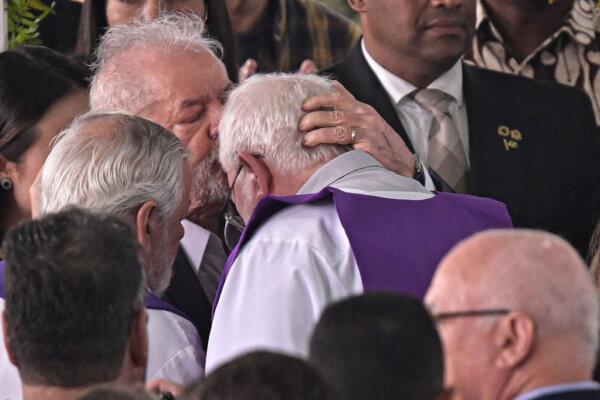 President of Brazil Luiz Inácio Lula da Silva kisses the priest during football legend Pele's funeral in Urbano Caldeira Stadium in Santos, Brazil, on Jan. 3, 2023. (Pedro Vilela/Getty Images)
