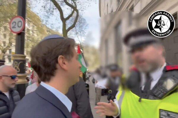 Gideon Falter speaking to a Metropolitan Police officer at a protest in central London on April 13, 2024. (Campaign Against Antisemitism/PA)