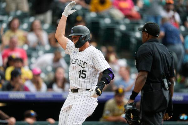 The Rockies' Hunter Goodman gestures as he crosses home plate after hitting a three-run home run against the Padres in Denver on April 25, 2024. (David Zalubowski/AP Photo)