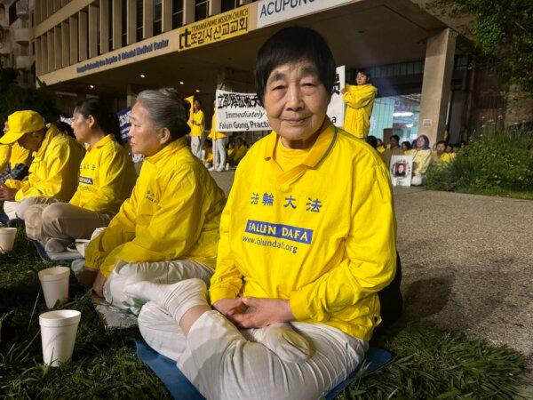 Falun Gong practitioner Li Shuying attends a candlelight vigil in front of the Chinese Consulate to mark the 25th anniversary of a peaceful appeal by 10,000 people in China in Los Angeles on April 21, 2024. (Linda Jiang/The Epoch Times)