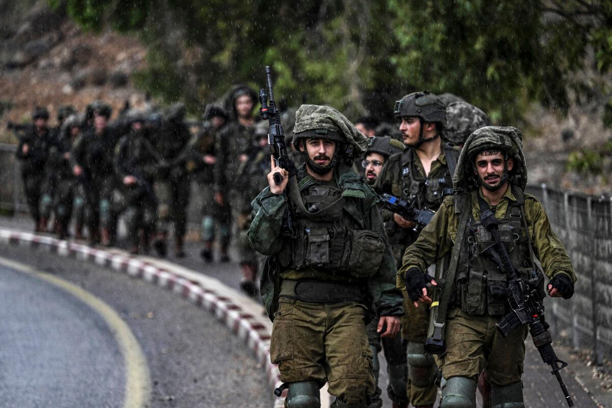 Israeli army soldiers patrol an undisclosed area in northern Israel bordering Lebanon on Oct. 15, 2023. (ARIS MESSINIS/AFP via Getty Images)