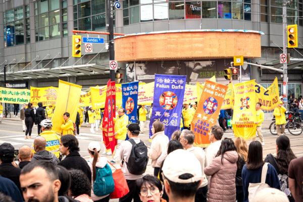 Falun Gong adherents paraded across downtown Toronto on May 11, 2024, celebrating the 32nd World Falun Dafa Day. (Evan Ning/The Epoch Times)