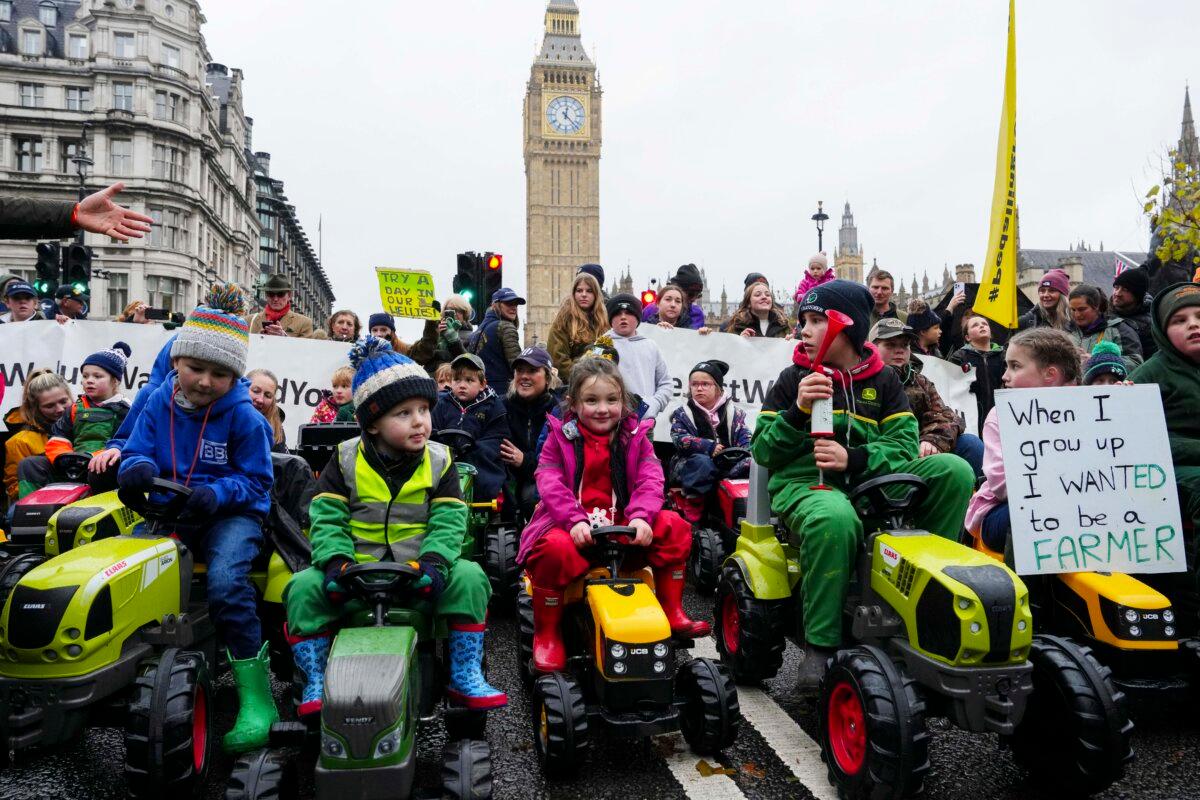 Children ride toy tractors in Parliament Square as demonstrators attend a farmers rally in London, on Nov. 19, 2024. (Carl Court/Getty Images)