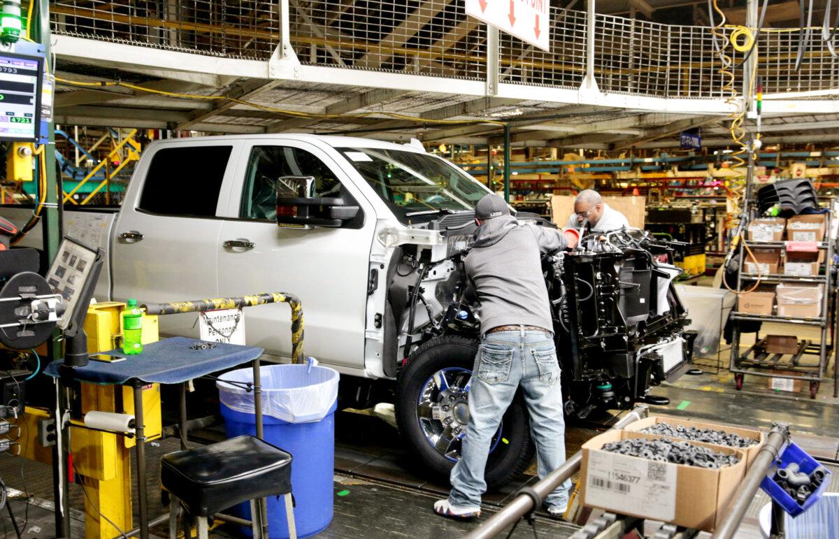 General Motors employees work on Chevrolet pickups at a plant in Flint, Mich., on Feb. 5, 2019. (Rebecca Cook/Reuters)