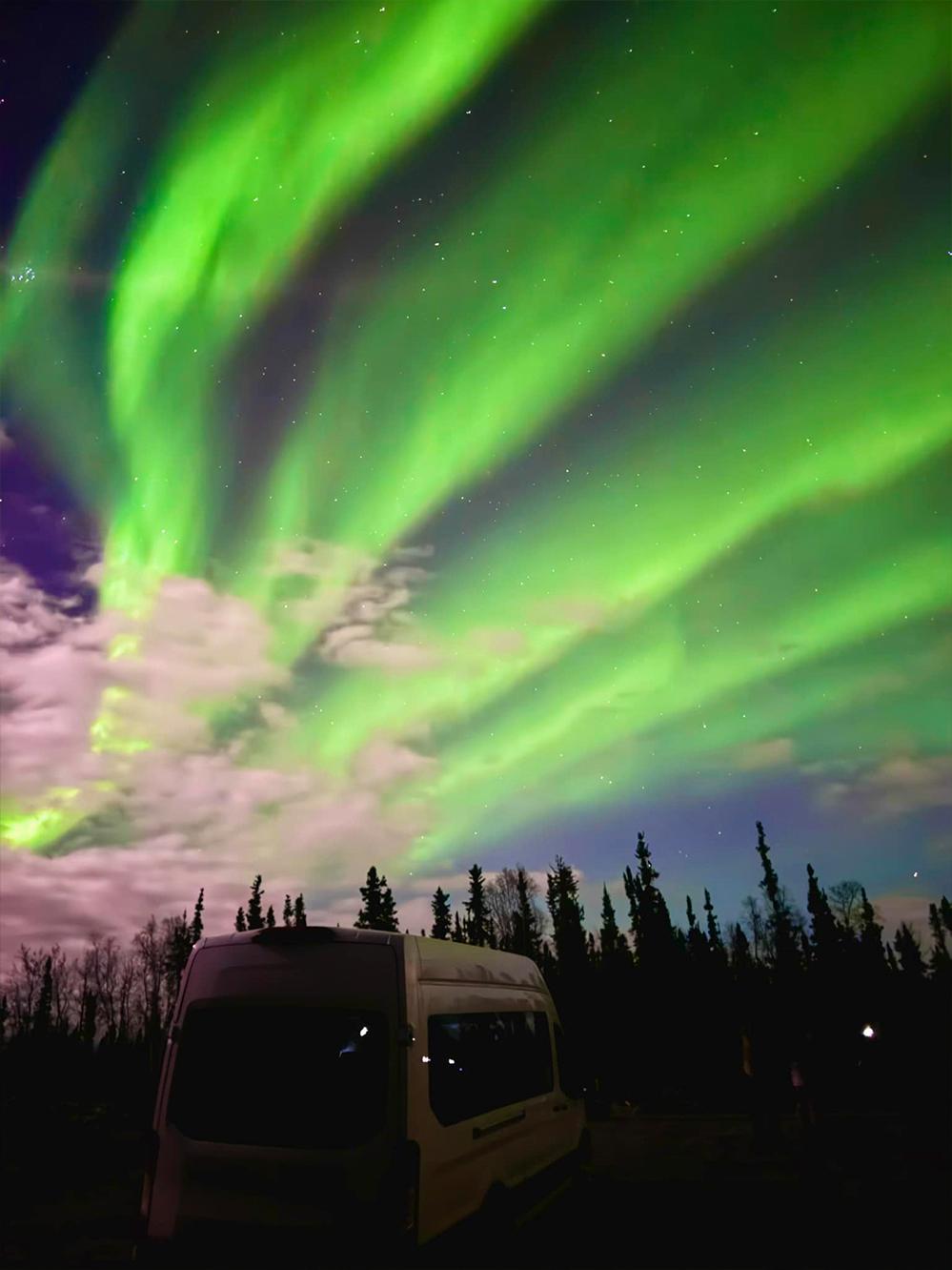 A tour witnesses an aurora on a cloudy evening. (Courtesy of Joe Buffalo Child)