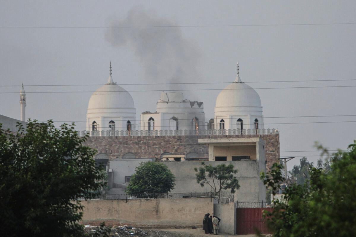 Local residents stand outside a mosque of an Islamic seminary partially damaged by a suspected Indian missile attack, on outskirts of Bahawalpur, Pakistan, on May 7, 2025. (Asim Tanveer/AP)