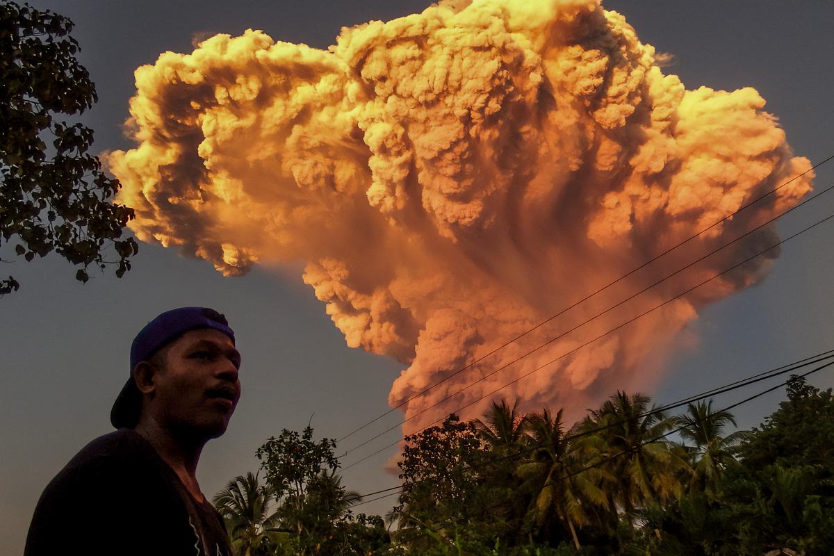 A villager watches the eruption of Mount Lewotobi Laki-Laki in Sikka, Indonesia, on June 17, 2025. (STR/AFP via Getty Images)