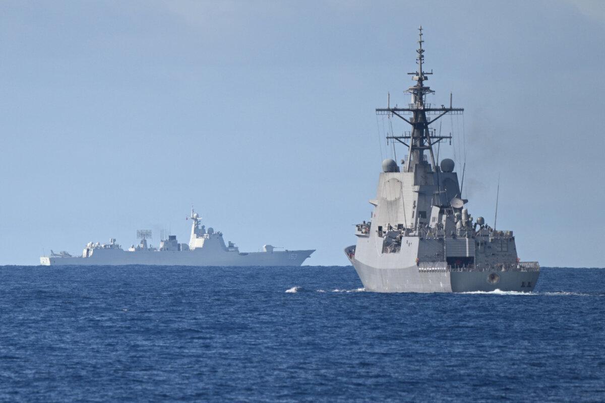 A Chinese PLA Navy ship (background L) is seen while the an Australian Navy destroyer (R) takes part in a maritime cooperative activity near Scarborough Shoal, on Sept. 3, 2025. (Ted Aljibe/AFP via Getty Images)