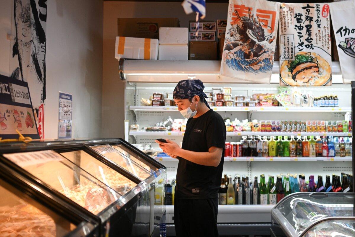 A worker is seen in a Japanese products supermarket in Beijing on Nov. 19, 2025. (Pedro Pardo/AFP via Getty Images)