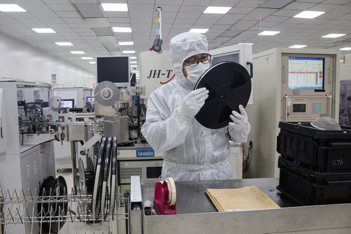An employee inspects semiconductor chips at a factory in Binzhou, Shandong Province, China, on Jan. 15, 2025. (STR/AFP via Getty Images)