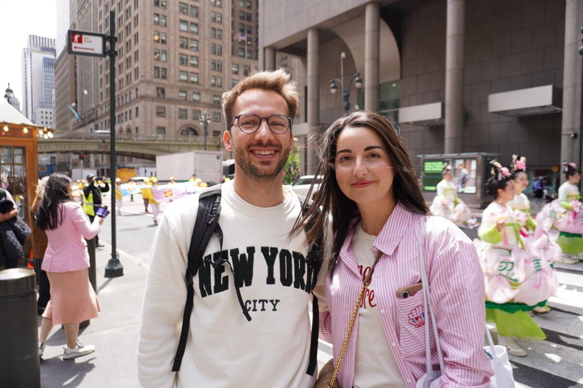 French lawyer Emma and her boyfriend, who were vacationing in New York, watched the Falun Dafa Day parade in Midtown Manhattan on May 13, 2026. (Yu Lili/The Epoch Times)