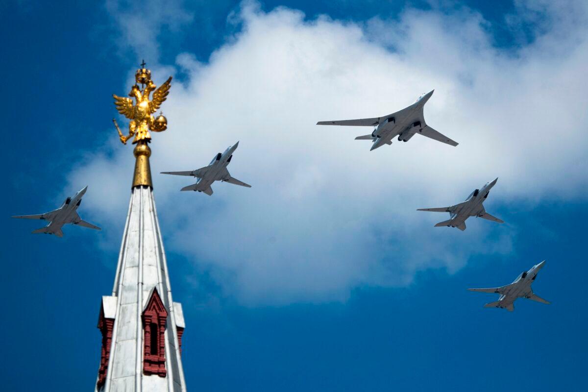 A Tupolev Tu-160 and Tu-22M3 military aircraft fly over Red Square during a military parade in Moscow, on June 24, 2020. (Pavel Golovkin/AFP via Getty Images)