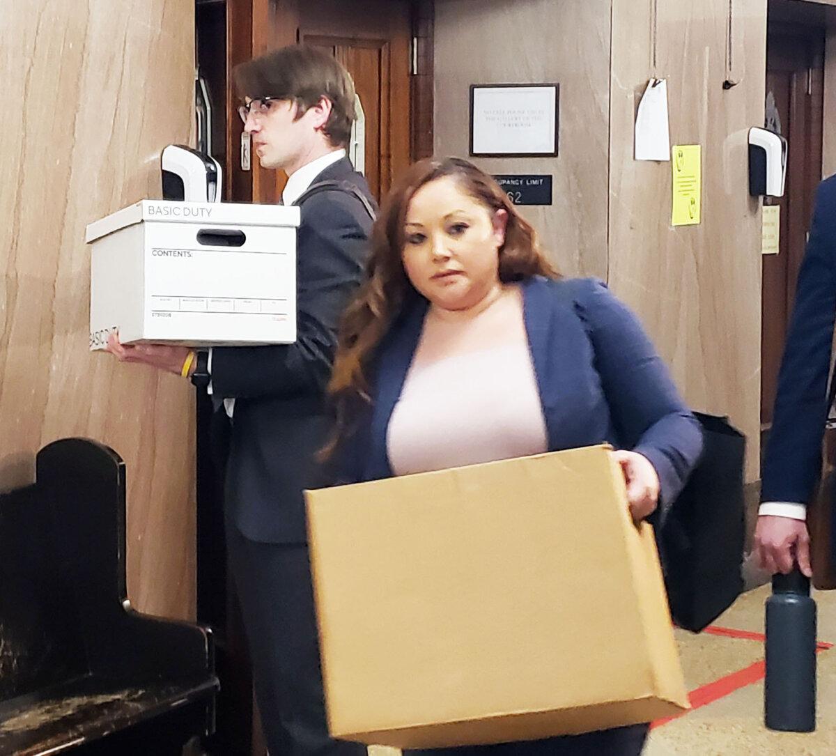 Assistant Attorneys General McKenzie McMahon (L) and Colleen Galaviz (R), leaving a District Court of Oklahoma County courtroom on March 25, 2024. (Michael Clements/The Epoch Times)
