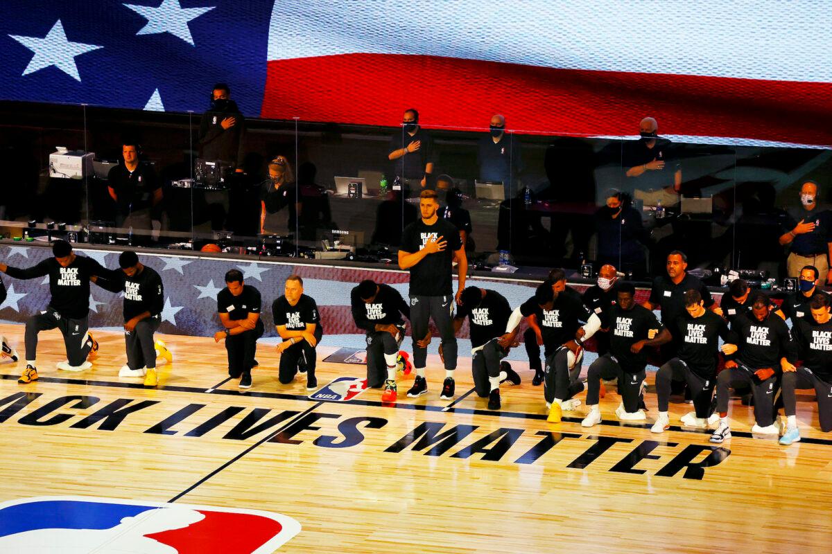 Miami Heat's Meyers Leonard stands during the national anthem before an NBA basketball game against the Denver Nuggets in Lake Buena Vista, Fla., on Aug. 1, 2020. (Kevin C. Cox/Pool Photo via AP)