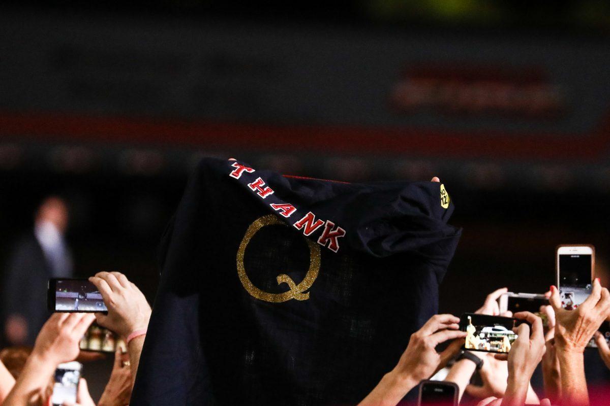 An attendee hols up a QAnon t-shirt at a Make America Great Again rally in Mesa, Ariz., on Oct. 19, 2018. (Charlotte Cuthbertson/The Epoch Times)