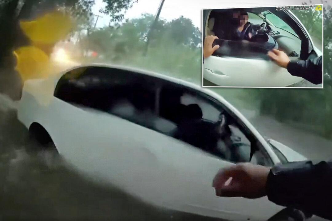 ‘I’m Going In’: Texas Policeman Rescues Baby From Car Trapped in Flash Flood