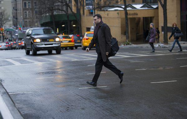 A pedestrian moves quickly outside of a crosswalk at the busy intersection of W. 96th Street and Broadway in the Upper West Side of New York City on Jan. 27, 2014. (Craig Ruttle/AP Photo)