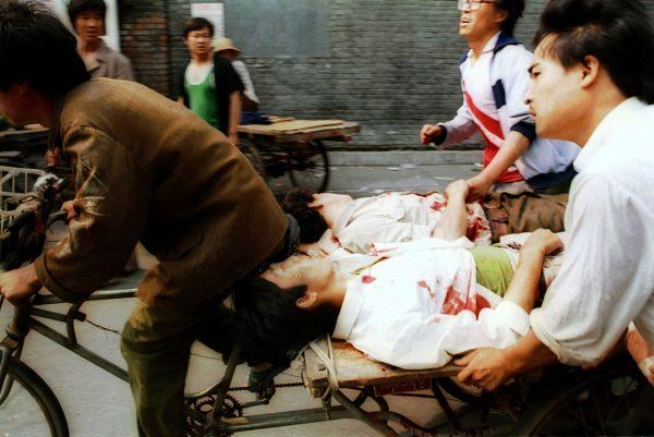 A rickshaw driver peddles wounded people, with the help of bystanders, to a nearby hospital after they were injured during clashes with Chinese soldiers at Tiananmen Square in Beijing, China, on June 4, 1989. The crackdown ended a period of relative political openness and led to the downfall of Communist Party leader Zhao Ziyang. (Liu Heung Shing/AP Photo)