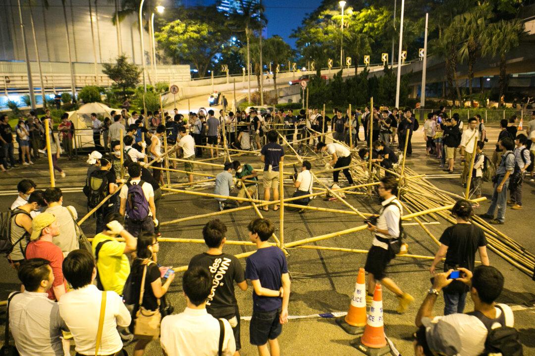Hong Kong Chief Travels to China, Moves Against Protesters Begin