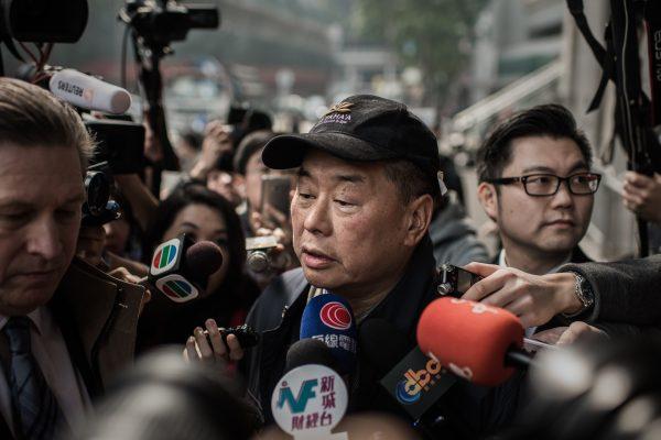 Outspoken media tycoon Jimmy Lai talks to the media after walking out of the Wanchai police station in Hong Kong on Jan. 21, 2015. (Philippe Lopez/AFP/Getty Images)