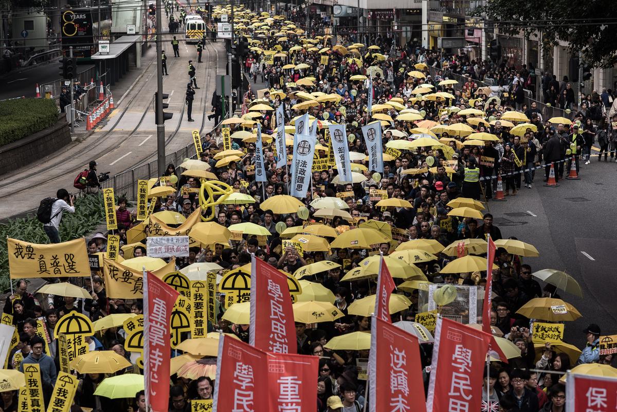 Hongkongers Raise Umbrellas, March to Protest Beijing’s Democracy Plan