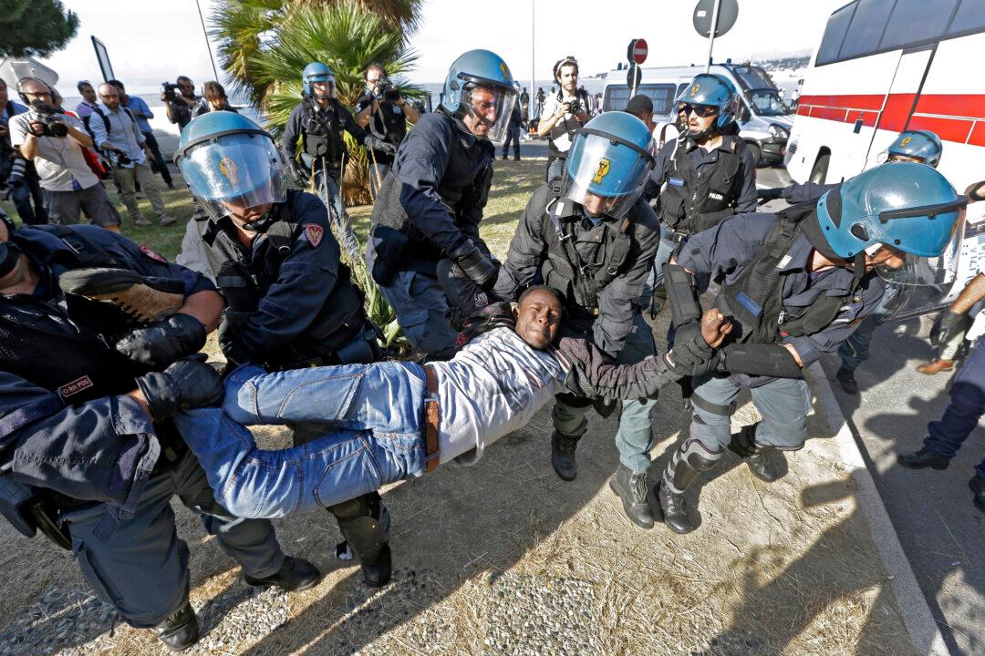 Police in Helmets Drag Migrants From French-Italian Border