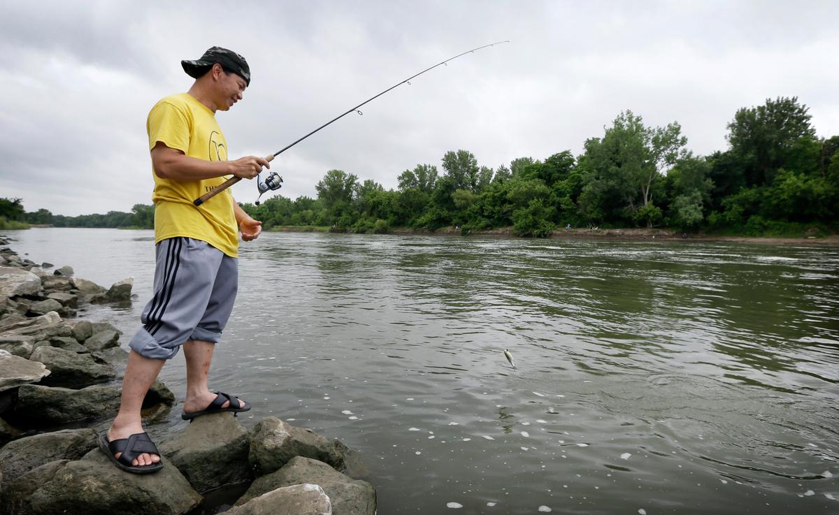 Poor, Immigrants Fish for Their Dinner, Unaware of Risks