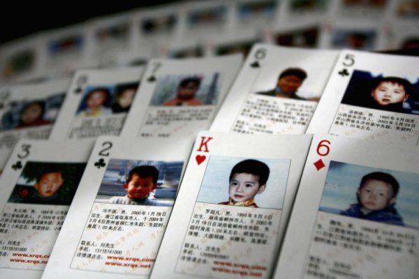 The "missing children playing cards" are displayed by Shen Hao, the founder of a missing person website, the www.xrqs.com, on March 31, 2007 in Beijing, China. The cards show photographs and informations about 27 missing children. Shen Hao hand them to public security departments, civil affairs bureaus ,and residents in areas notorious for child trafficking. (China Photos/Getty Images)