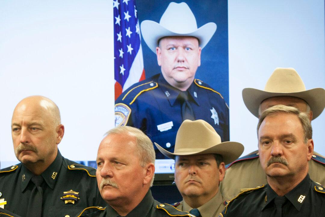 Police: Hunt Won’t Stop for Suspects in Officer’s Death