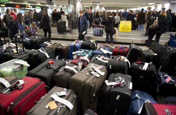 Unclaimed bags in the foreground as travelers retrieve their luggage at New York's La Guardia Airport. LGA was rated the worst U.S. airport in a recent reader survey, including for handling of luggage. (Don Emmert/AFP/Getty Images)