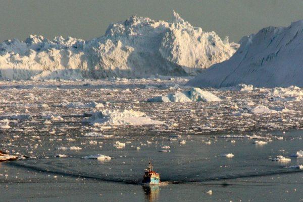 A boat skims through the melting ice in the Ilulissat fjord on the western coast of Greenland in August 2008. (Steen Ulrik Johannessen/AFP/Getty Images)