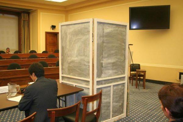 A young woman testifies before Congress in Washington, D.C., on Nov. 10, 2009, under the assumed name "Wujian" about her ordeal of being hunted down and dragged to a population control center and subjected to an unwanted abortion in China. (Gary Feuerberg/ The Epoch Times)