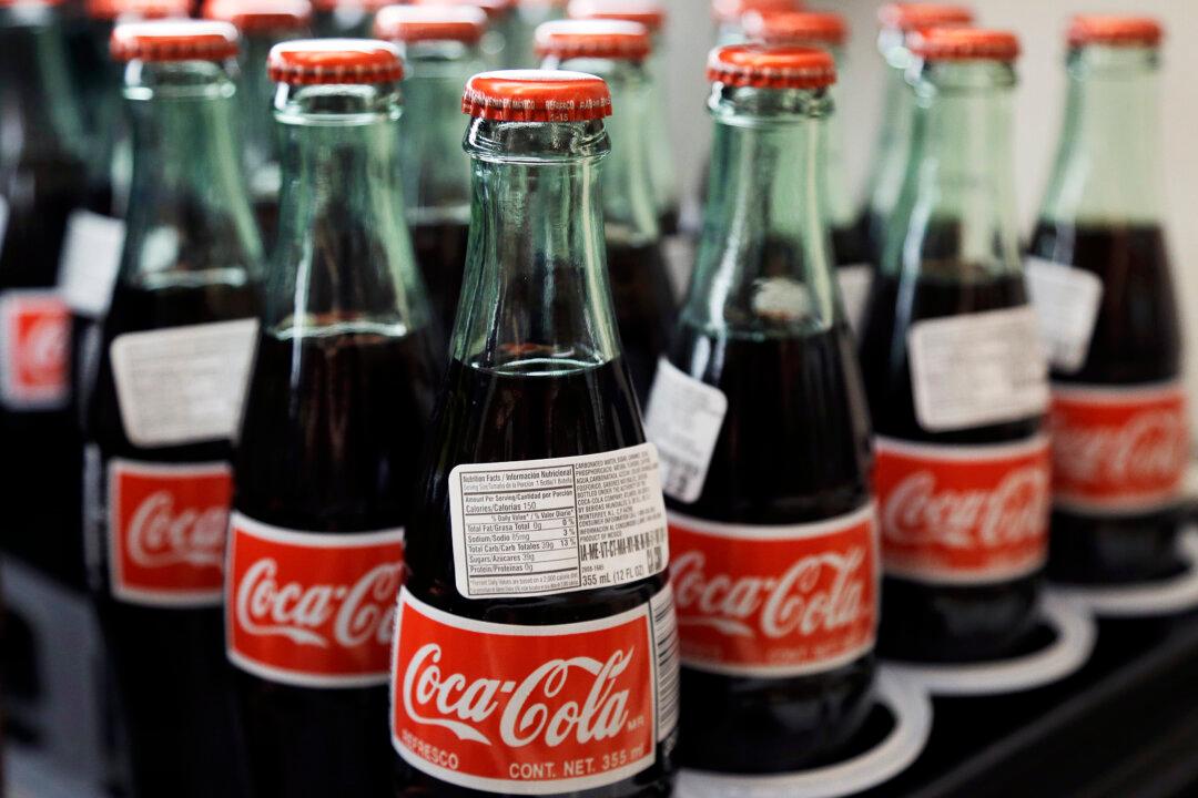 Coke’s Profit Hit by Strong Dollar, Repositioning