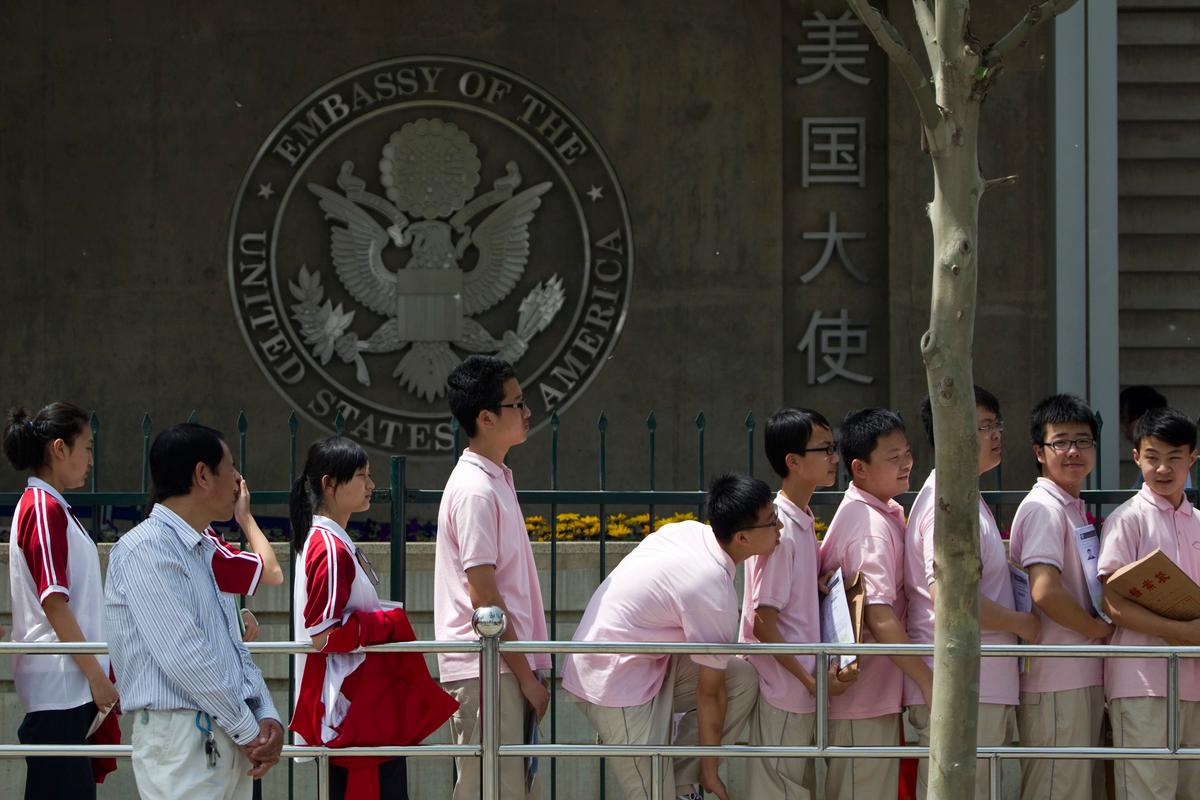 Chinese students wait outside the U.S. Embassy for their visa application interviews in Beijing, China., in a file photo. (Alexander F. Yuan/AP Photo)