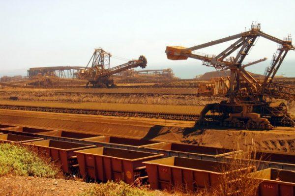 Stackers and reclaimers moving iron ore to rail cars at Rio Tinto's Port Dampier operations in Western Australia's Pilbara region in 2010. China's deepening slowdown is likely to have an outsize impact on Australian miners. (Amy Coopes/AFP/Getty Images)