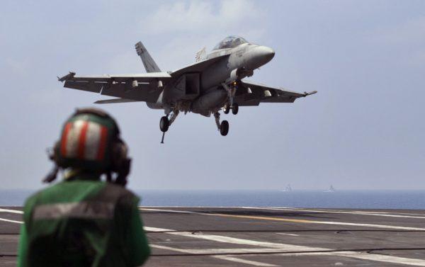 A U.S. Navy fighter jet approaching to land on the U.S. Navy aircraft carrier USS Theodore Roosevelt during Exercise Malabar 2015 about 150 miles off Chennai, India, on Oct. 17, 2015. (Arun Sankar K./AP Photo)