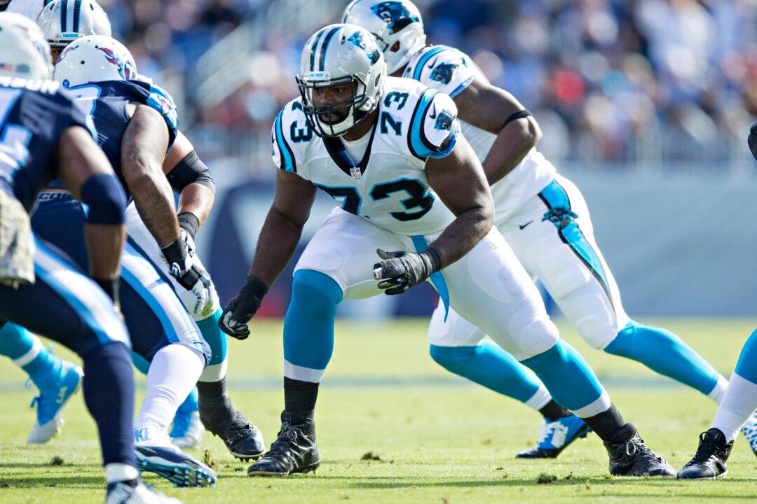 Panthers Tackle Michael Oher Posts Picture With Adoptive Parents on Field After Carolina Win