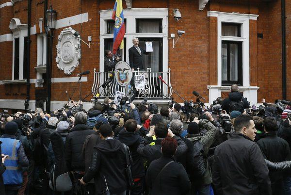 Wikileaks founder Julian Assange. holding a U.N. report, speaks on the balcony of the Ecuadorean Embassy in London on Feb. 5, 2016. (Kirsty Wigglesworth/AP Photo)