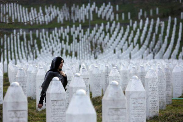 A Bosnian woman walks among gravestones at Memorial Center Potocari near Srebrenica, Bosnia and Herzegovina, on March 20, 2016. (Amel Emric/AP Photo)
