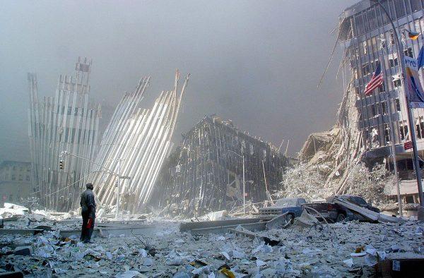 A man standing amid rubble, calling out asking if anyone needs help, following the collapse of the first World Trade Center tower in New York after two hijacked planes crashed into the buildings. (Doug Kanter/AFP/Getty Images)