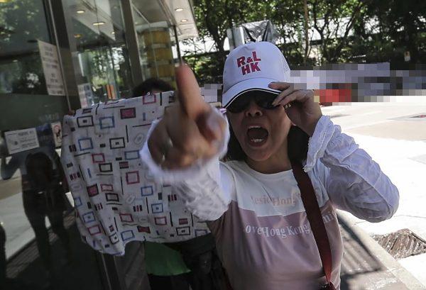 A member of the Hong Kong Youth Care Association communist front group outside Macpherson Stadium in Mong Kok, Hong Kong on July 24, 2016. (Yu Kong/The Epoch Times)